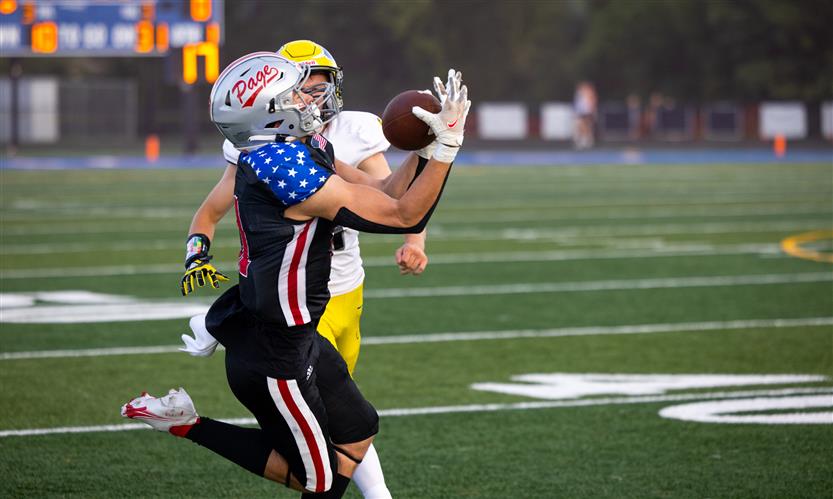 A football player runs the ball down the field